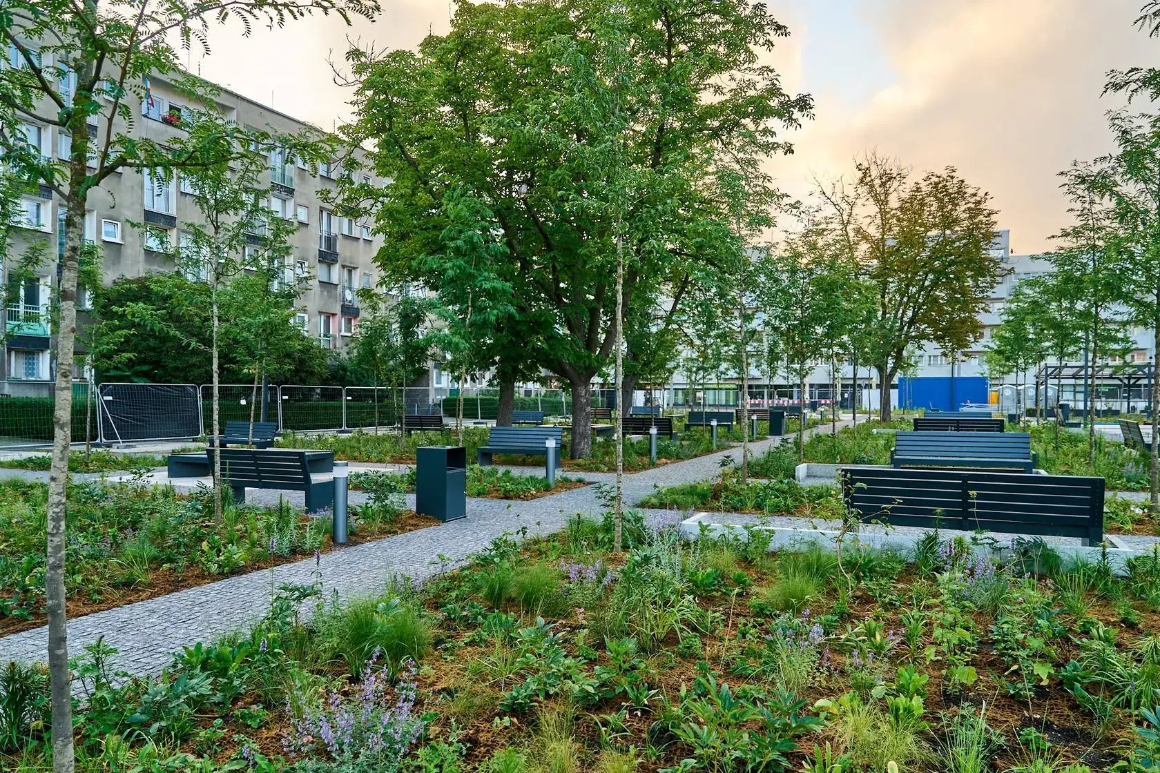 Nowoczesny park miejski z alejkami, ławkami i dużą ilością zieleni